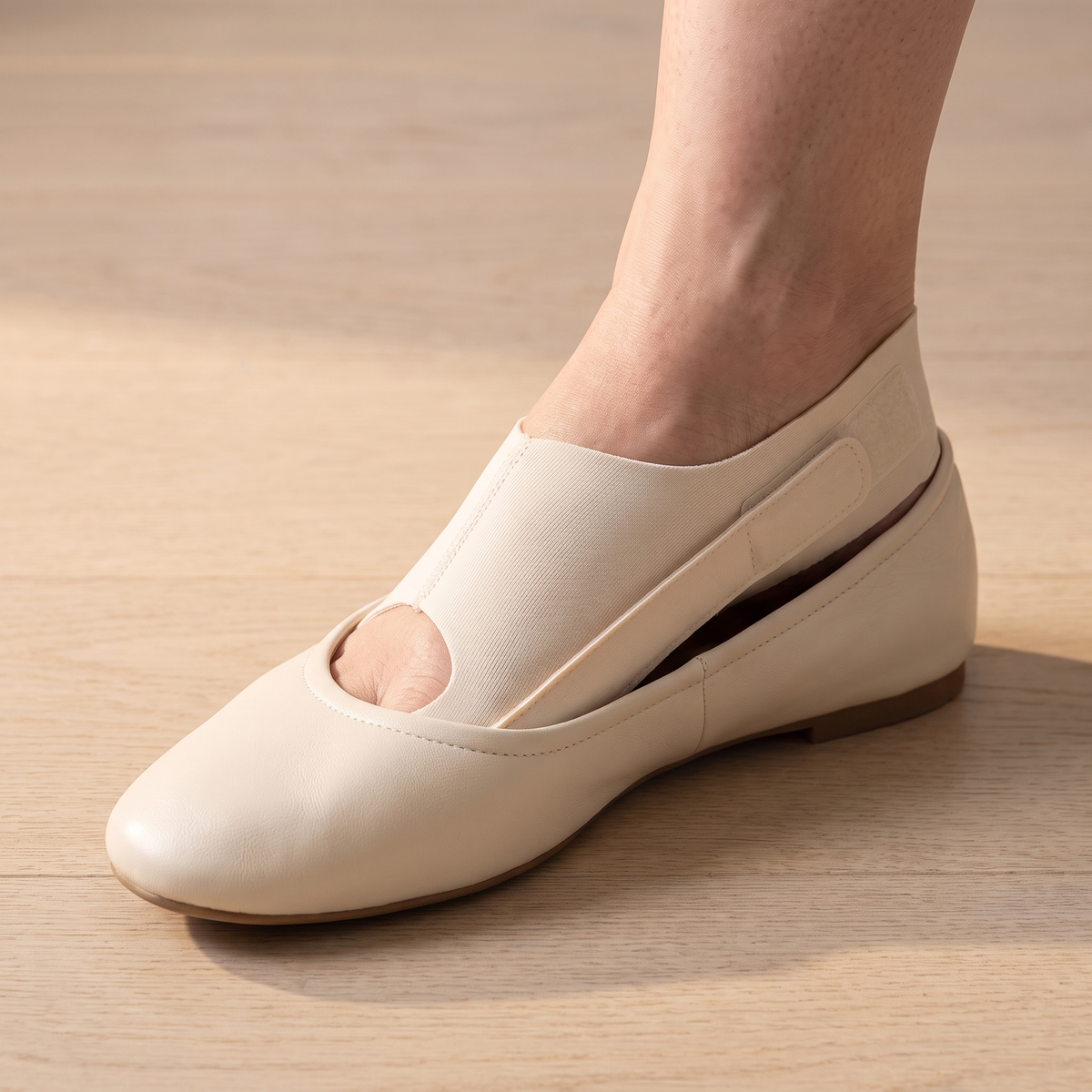 TrueToe strap worn inside a cream leather flat, the shoe sitting flat with no bulge